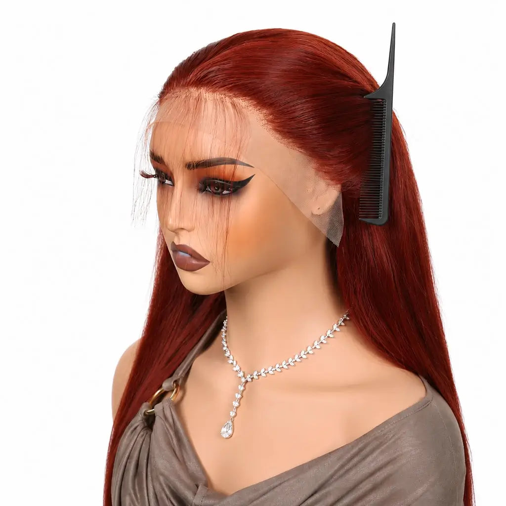 Reddish brown wig on a mannequin head with a comb, against a white background