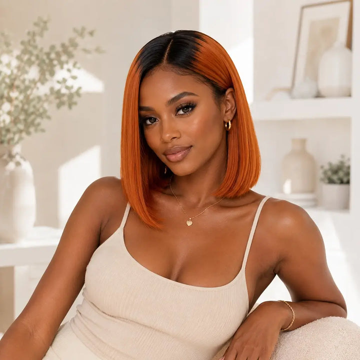 Young black women wearing a ginger ombre bob wig with black roots in a short straight bob style