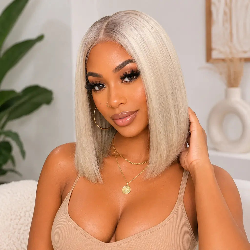woman wearing a short platinum blonde ombre bob wig with dark roots straight lace front human hair