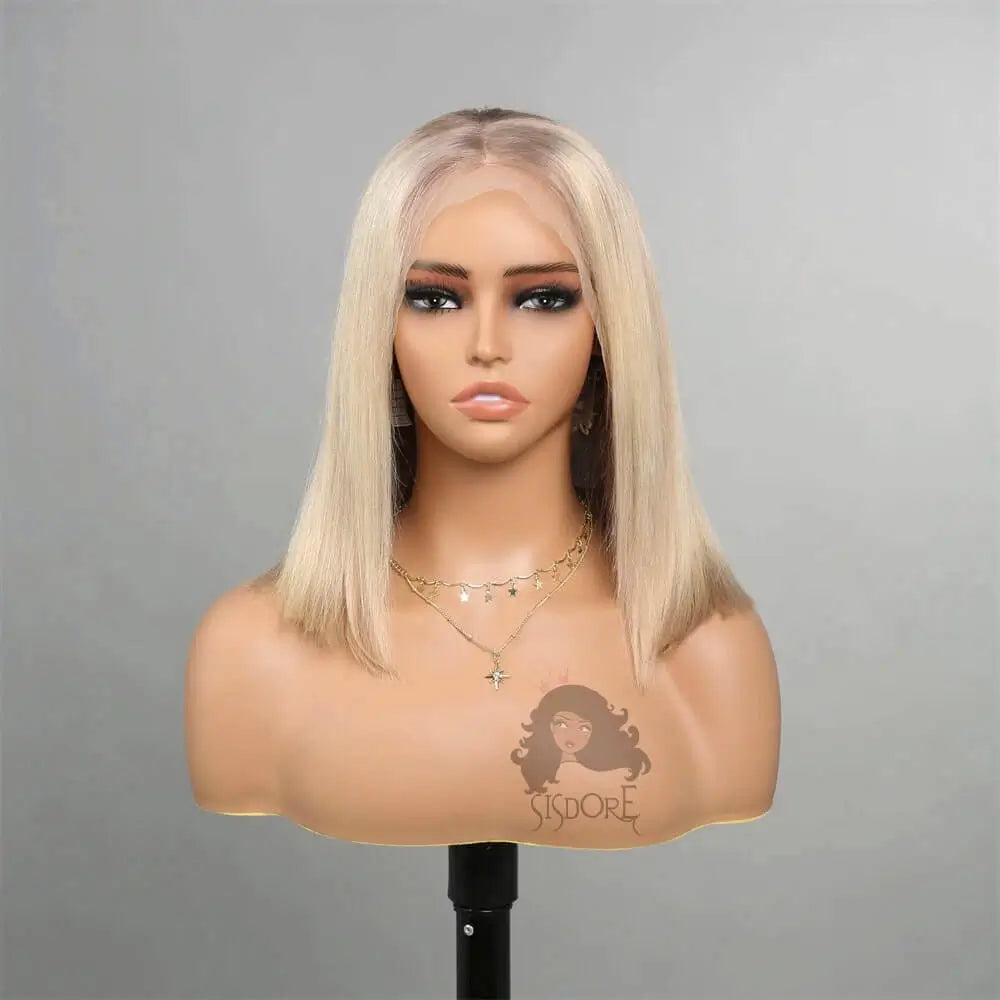 Platinum blonde straight bob wig on a mannequin head with a gray background