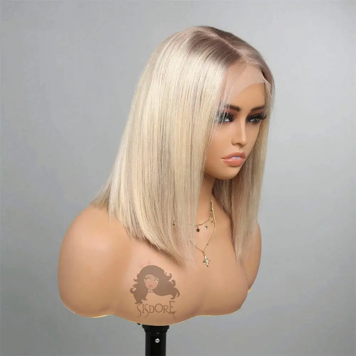 Side view of a straight platinum blonde ombre bob wig with dark roots, showing sleek texture and soft blended color